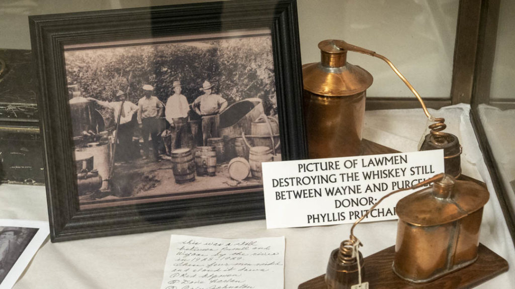 Photo of Lawmen destroying whiskey still